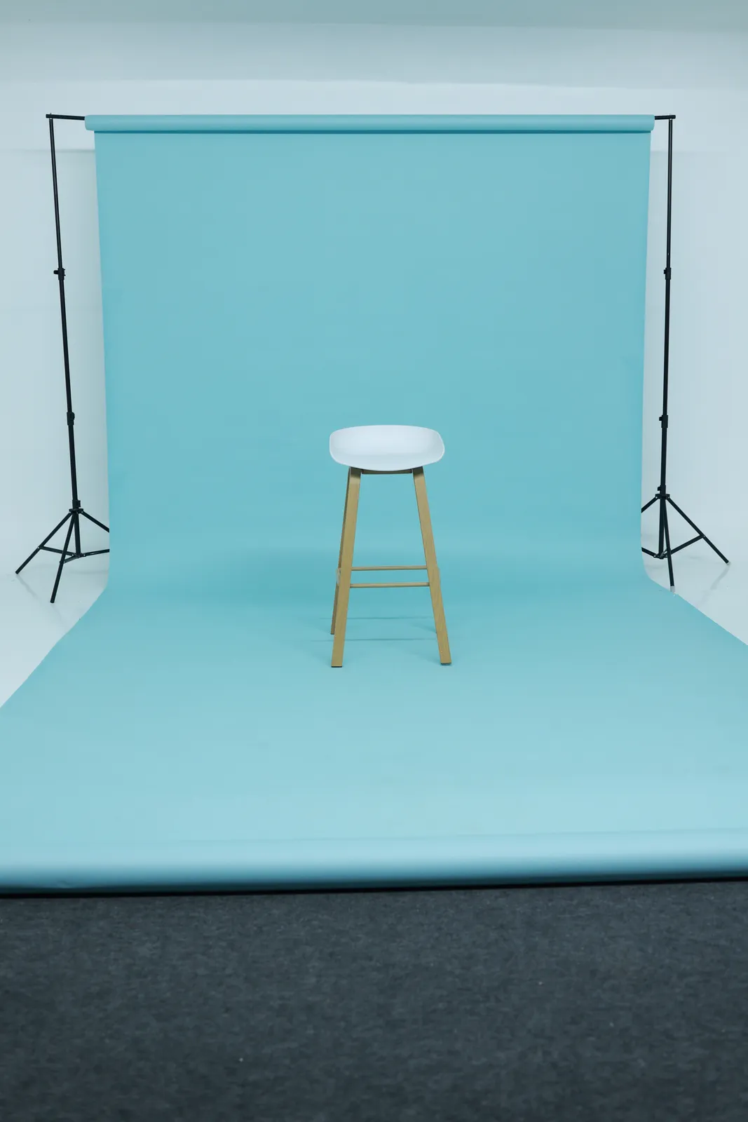 Aqua seamless paper installed across the studio wall and floor.